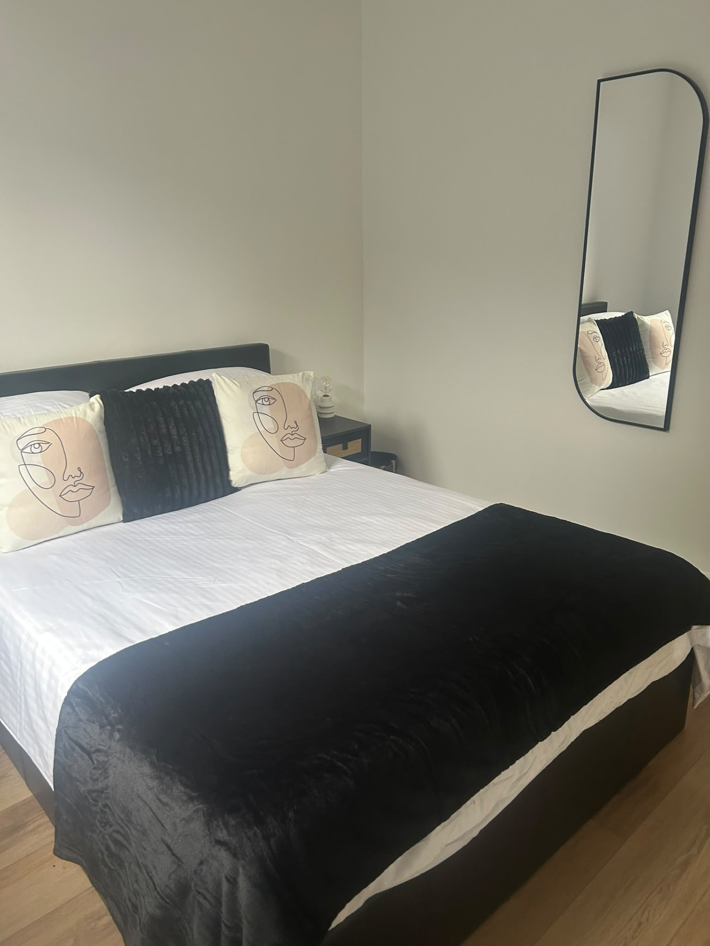 Second Hub 16 bedroom with decorative cushions and mirror
